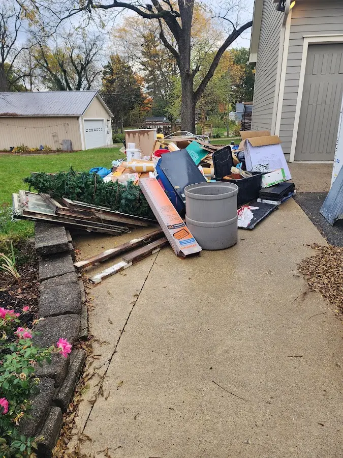 Dumpster being loaded with debris for 12 Yard Dumpster Rental in Buffalo
